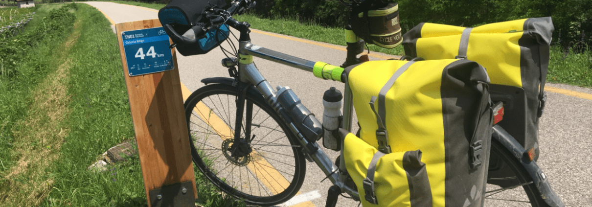 Fahrrad mit gelben Gepäcktaschen am Radweg TN01 bei Kilomter 44